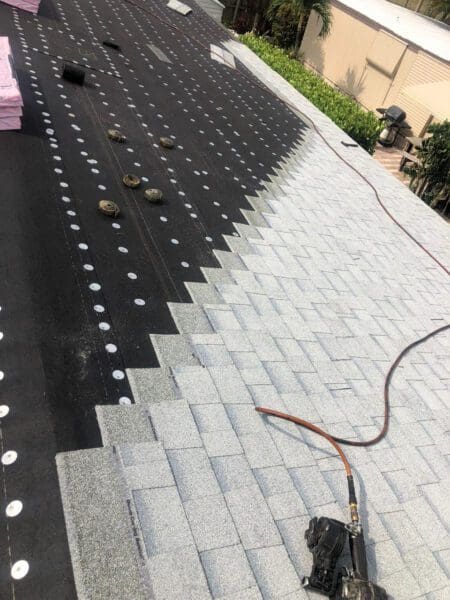 Contractors installing tile onto a roof