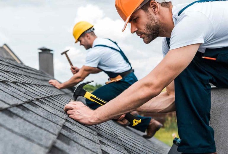 Roofing experts installing a roof