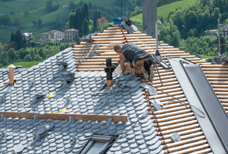Worker performing routine maintenance on roof