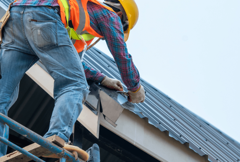 Roofer repairing a metal roof
