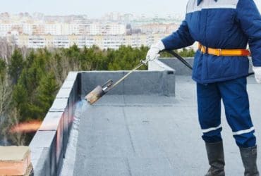 Roofer installing commercial roofing system