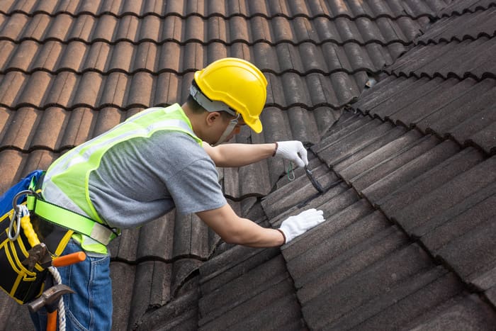 roof repair expert working on roof maintenance