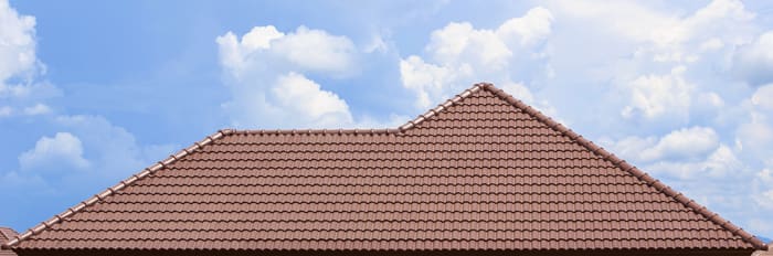 roof under construction with stacks of roof tiles for home build