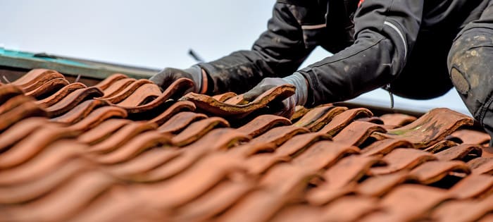 roofing expert working on damaged residential roof