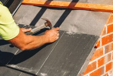 Roofer working on commercial roof repairs