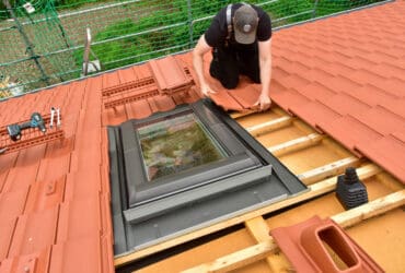 roofer checking roof for new roof installation