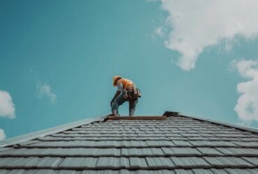 A roofer working on the roof repair of a home