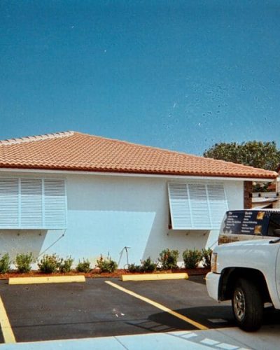 beautiful home car parked outside with surrounded palm trees